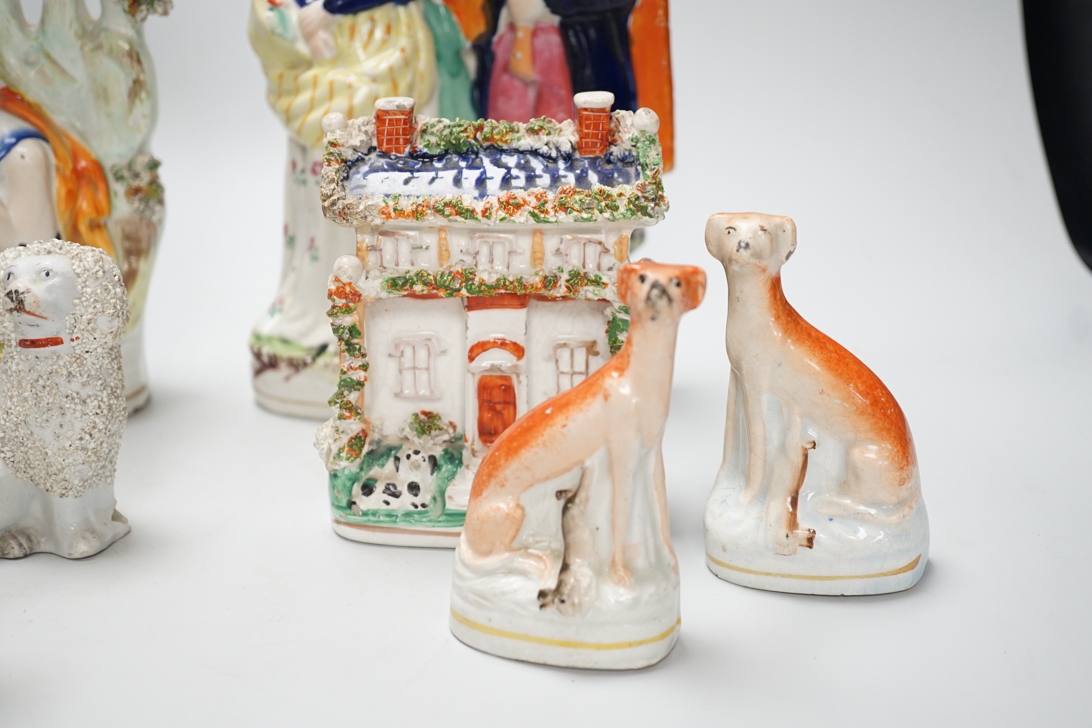 A selection of Staffordshire figure groups, greyhounds, spaniels, etc. tallest 26.5cm